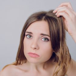 Mask stress vitamits concept. Close up photo of sad unhappy worried frustrated nervous upset girl looking examining expertizing her damaged in bad condition hair isolated on gray background copy-sapce