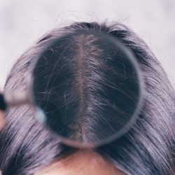 young girl checks her hair